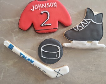 Sugar cookies. Hockey pucks, hockey sticks, hockey skates, hockey emblems.