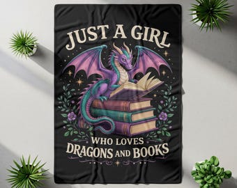 May include: A black rectangular throw blanket featuring a purple dragon perched on a stack of three books. The text reads JUST A GIRL WHO LOVES DRAGONS AND BOOKS. The design includes green leafy vines, small purple flowers, and gold star accents.