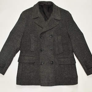 May include: A dark grey double-breasted peacoat with a textured fabric. The coat has two front pockets and a button closure.