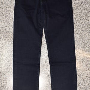 May include: Dark blue denim jeans with a small logo on the left pocket.
