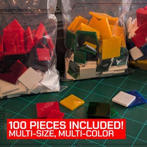 May include: Multi-colored, multi-sized pieces in clear bags. The pieces are red, yellow, green, white, and blue. The text "100 PIECES INCLUDED! MULTI-SIZE, MULTI-COLOR" is in a red box at the bottom.
