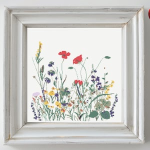 May include: A framed cross-stitch pattern featuring a colorful bouquet of wildflowers, including red poppies, yellow wildflowers, and blue wildflowers.