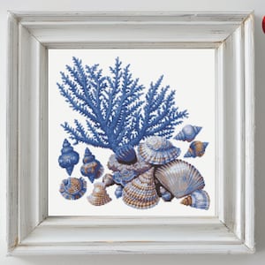 May include: A blue coral reef with a cluster of seashells in shades of blue and gold. The shells are arranged in a decorative pattern.