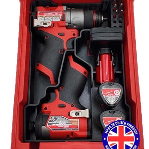 May include: A red and black cordless drill and impact driver set in a red case. The set includes two drills, batteries, and drill bits. The case has a clear lid and a label that says "Made in United Kingdom".