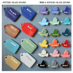 May include: A collection of ceramic glaze color samples in the shape of tags and birds. The colors include purple, blue, red, shino, aqua, pale green, yellow, white, black, brown, gray, periwinkle, light blue, teal, celadon, pea green, orange, dusty pink, and coral pink.