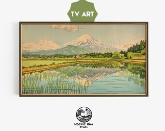 May include: A vintage woodblock print depicting Mount Fuji reflected in a still lake. The mountain is snow-capped and surrounded by lush green trees and fields. The print is framed in a dark wood frame.