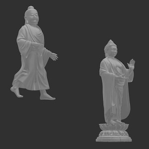 May include: Two gray Buddha statues. One is depicted walking with a serene expression, draped in flowing robes. The other stands on a lotus flower base, with one hand raised in a gesture of blessing, also wearing robes.