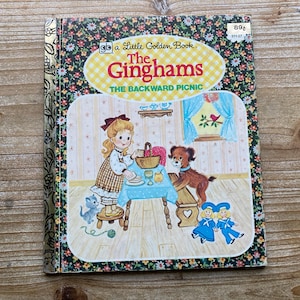 May include: A Little Golden Book titled "The Gingham's The Backward Picnic". The cover features a girl with blonde hair in a plaid dress, a dog, and two girls in blue dresses.
