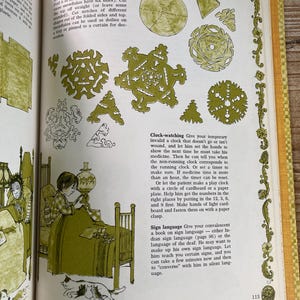 May include: An open book with illustrations and text. The page features instructions for making paper snowflakes, a drawing of a child, and text about clock-watching and sign language. The illustrations are in green and black.