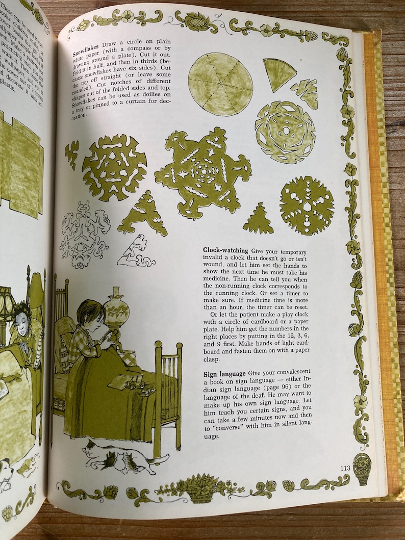 May include: An open book with illustrations and text. The page features instructions for making paper snowflakes, a drawing of a child, and text about clock-watching and sign language. The illustrations are in green and black.