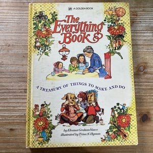 May include: A vintage Golden Book titled "The Everything Book." The cover features illustrations of children, adults, and whimsical characters. The book's title is in red script, with the subtitle "A Treasury of Things to Make and Do."