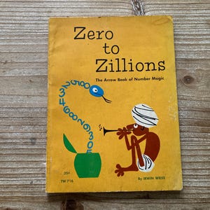 May include: A yellow book titled "Zero to Zillions: The Arrow Book of Number Magic" by Irwin Weiss. The cover features a cartoon illustration of a snake made of numbers and a person playing a musical instrument.