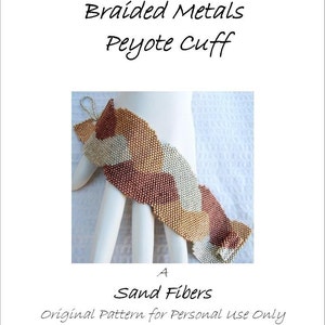 May include: A braided metal cuff bracelet in a peyote stitch pattern. The bracelet is made with copper, silver, and gold beads and has a wavy design. The bracelet is on a white surface.