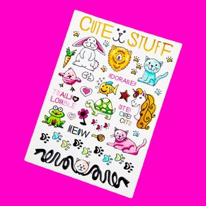 May include: A white sheet with colorful illustrations of cute animals and the words "CUTE STUFF", "ADORABLE!!", "TOTALLY LOVABLE", and "MEOW". The illustrations include a bunny, lion, cat, fish, frog, turtle, unicorn, and more.