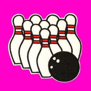 May include: A white and red bowling pin set with a black bowling ball. The pins are arranged in a triangle shape with the ball in front.