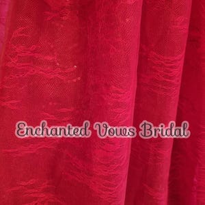 May include: Red lace fabric with sequins. The fabric has a delicate, flowing pattern and is perfect for adding a touch of elegance to any project. The fabric is also very soft and comfortable to wear.