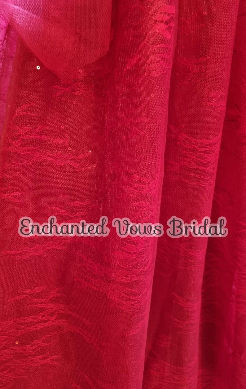 May include: Red lace fabric with sequins. The fabric has a delicate, flowing pattern and is perfect for adding a touch of elegance to any project. The fabric is also very soft and comfortable to wear.