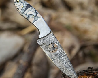 Der aus Damaststahl gefertigte Skinner mit fester Klinge. Dieser Skinner ist ideal zum Jagen, Häuten, Camping und für verschiedene Outdoor-Aktivitäten.