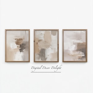 May include: Three framed abstract art prints. Each print features a neutral color palette of beige, brown, and white brushstrokes. The frames are made of light brown wood. The text "Digital Decor Delight" is below the prints.
