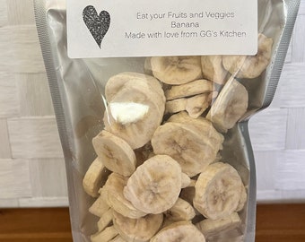 May include: A clear plastic bag filled with dried banana slices. The bag has a label that reads "Eat your Fruits and Veggies Banana Made with love from GG's Kitchen".