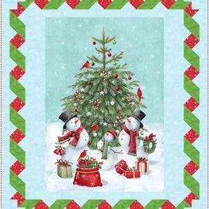 May include: A festive Christmas quilt with a central image of snowmen, a decorated Christmas tree, and presents. The scene is framed by a green and red geometric border. The snowmen wear top hats and scarves, and the tree is decorated with baubles.
