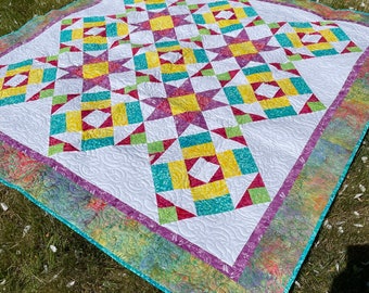 Showy Stars print quilt pattern to make a lap size quilt in bright colors - New Patten for Spring 2023