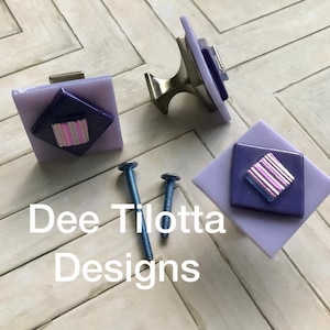 May include: A set of three ceramic mugs with a speckled, matte finish. The mugs are in shades of cream, light gray, and dark gray. Each mug has a simple, minimalist design, perfect for coffee or tea.