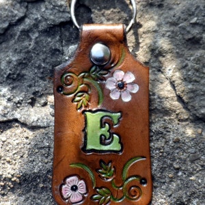 May include: A set of three ceramic nesting bowls in graduating sizes. The bowls are white with a blue floral pattern. The largest bowl is approximately 6 inches in diameter.