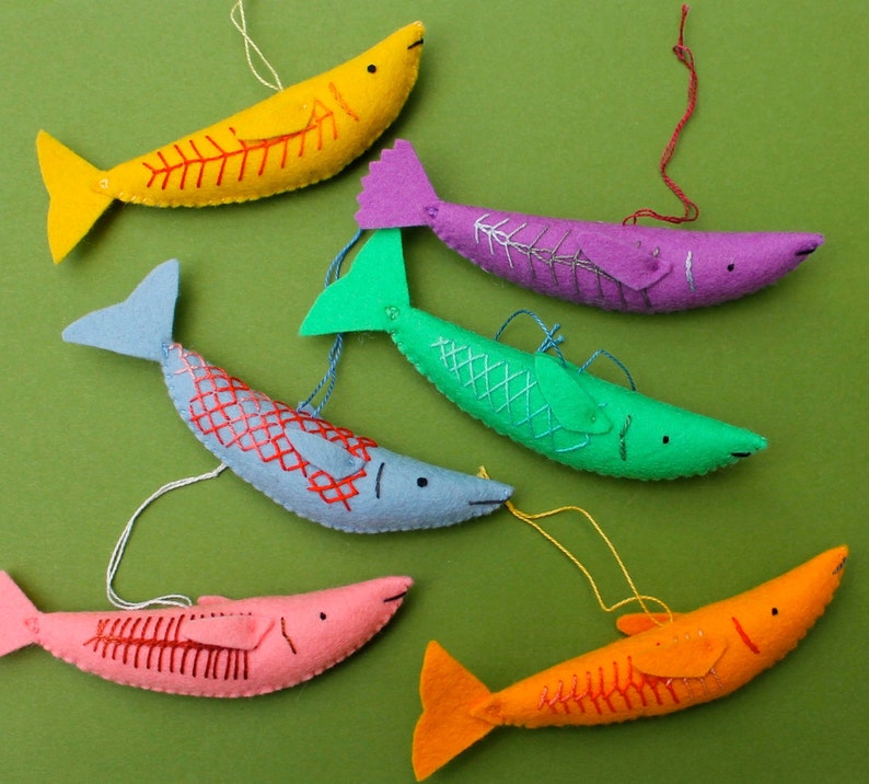 May include: A set of ten felt fish toys in various colors, including blue, green, purple, pink, and yellow. Each fish has embroidered details and a hanging loop.