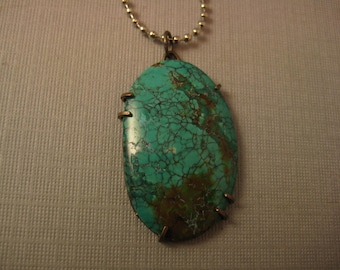 Turquoise pendant on chain  wide oval