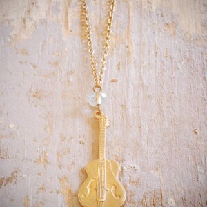 little vintage guitar charm necklace. repurposed old guitar charm & aqua blue czech glass bead on antiqued brass chain. ooak by val b.