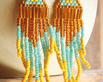 native american navajo style seed bead chandelier earrings of rusty brown, teal blue and mustard yellow. hand woven by val b.