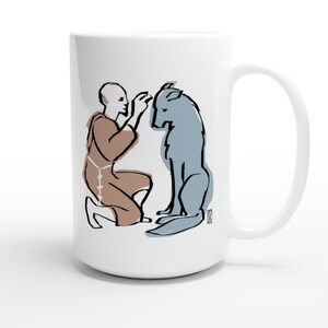 May include: White ceramic mug featuring an illustration of a person in a brown robe kneeling and interacting with a blue wolf. The artwork has black outline details. The mug has a large handle.