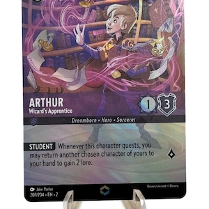 May include: A purple, blue, and gold fantasy trading card featuring a young wizard named Arthur, with the text "Arthur, Wizard's Apprentice" and "Dreamborn, Hero, Sorcerer". The card has a cost of 3, a power of 1, and a defense of 3. The card text reads "Student: Whenever this character quests, you may return another chosen character of yours to your hand to gain 2 lore."