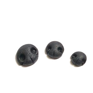 May include: Three black, textured, dog nose-shaped craft pieces of varying sizes. Each has two nostril holes and a central groove. The pieces are arranged on a white background.
