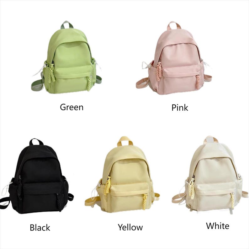 May include: Five different colored backpacks with zippered pockets and drawstrings. The backpacks are green, pink, black, yellow, and white.