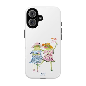 May include: White phone case with a colorful illustration of two frogs wearing hats and dresses. The text "NT" is printed on the bottom of the case.