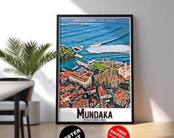 May include: A framed poster print featuring an aerial view of Mundaka, Basque Country, Spain. The image showcases a coastal town with red-tiled roofs, a church, and a vibrant blue ocean with waves. Text includes "World's Best Surf Spots" and "Mundaka."