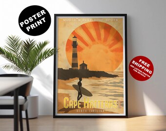 May include: Framed poster print featuring a vintage travel design. The artwork depicts a lighthouse, surfer, and the text "Cape Hatteras, North Carolina" against a sunset backdrop. The poster is in a black frame.