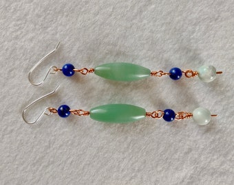 May include: A pair of dangle earrings with a green oval-shaped stone, blue round beads, and copper wire.