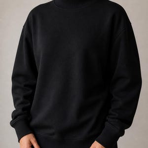 May include: A black sweatshirt with a high neck and ribbed cuffs and hem. The sweatshirt is made of a soft, comfortable material. The sleeves are long and the fit is relaxed.