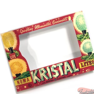 May include: Red and white cardboard box with a clear plastic window. The box is for Noma Kristal Lites with General Electric Electric Lamps. The box has a festive design with sparkling illuminated ornaments and the text "Sparkling Illuminated Ornaments".