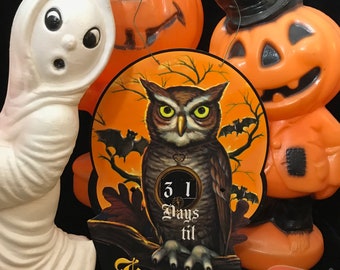 May include: A vintage Halloween countdown plaque with an orange background and a black and brown owl perched on a branch. The owl is holding a clock face that reads "31 Days til Halloween". There are bats flying around the owl and the text "Halloween" is written in a gothic font at the bottom of the plaque.