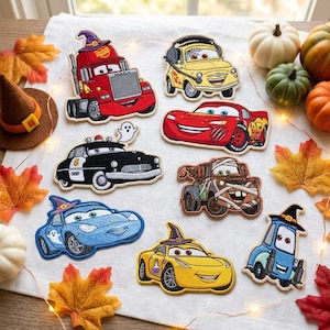 May include: A collection of embroidered patches featuring characters from the movie Cars, including a red truck with a witch hat, a yellow car with headphones, a red race car, a black police car, a brown tow truck, and other themed vehicles.