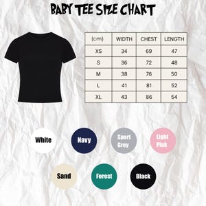 Puede incluir: Una camiseta negra para beb&eacute; se muestra junto a una tabla de tallas en cent&iacute;metros. La tabla enumera las medidas de ancho, pecho y largo para las tallas XS a XL. Las opciones de color incluyen blanco, azul marino, gris deportivo, rosa claro, arena, bosque y negro.