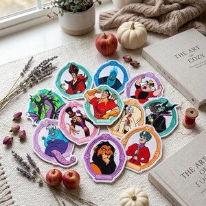 May include: A collection of circular embroidered patches featuring various animated villains, each framed in a decorative border. The patches display characters including Jafar, Hades, Gaston, Maleficent, Dr. Facilier, Cruella de Vil, Ursula, Scar, and Lady Tremaine in vibrant colors.