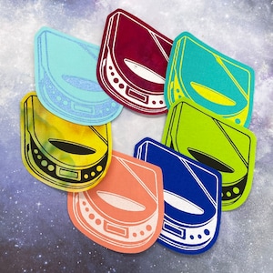 May include: Six colorful vinyl record player stickers with a retro design. The stickers feature different colors and designs, including blue, green, yellow, red, and orange.