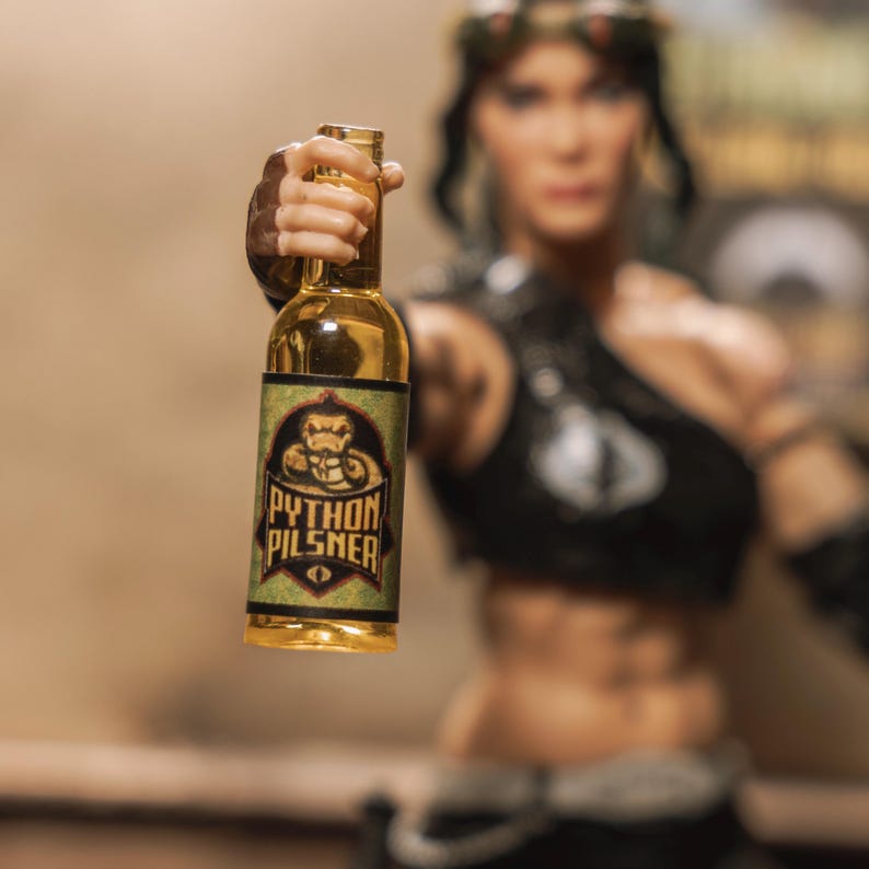 May include: A glass bottle with a yellow liquid and a label that says "Python Pilsner" with a green snake graphic.