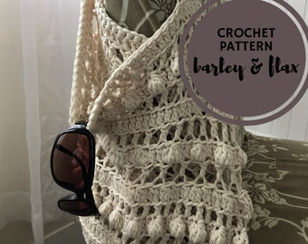 May include: A crocheted bag with a beige color and a textured pattern. The bag has a fringe detail and pom-poms. The bag is hanging on a chair with a floral pattern. The text "CROCHET PATTERN barley & flax" is visible in the image.