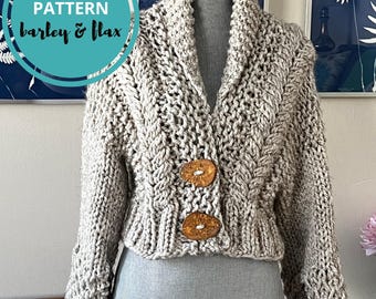 May include: A chunky knit cardigan in a light beige color, featuring a shawl collar and two large wooden buttons. The knitting pattern is visible, and the text "KNITTING PATTERN barley & flax" is in a teal circle.